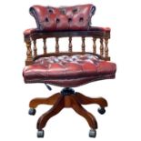 A 20th Century red leather upholstered revolving Captains style office chair, 65cm wide