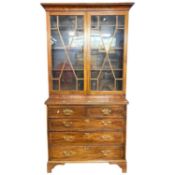 An 18th Century and later combination bookcase chest with two glazed doors over a base with two