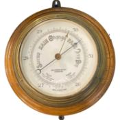 A barometer mounted on wooden base by John Barker, Kensington