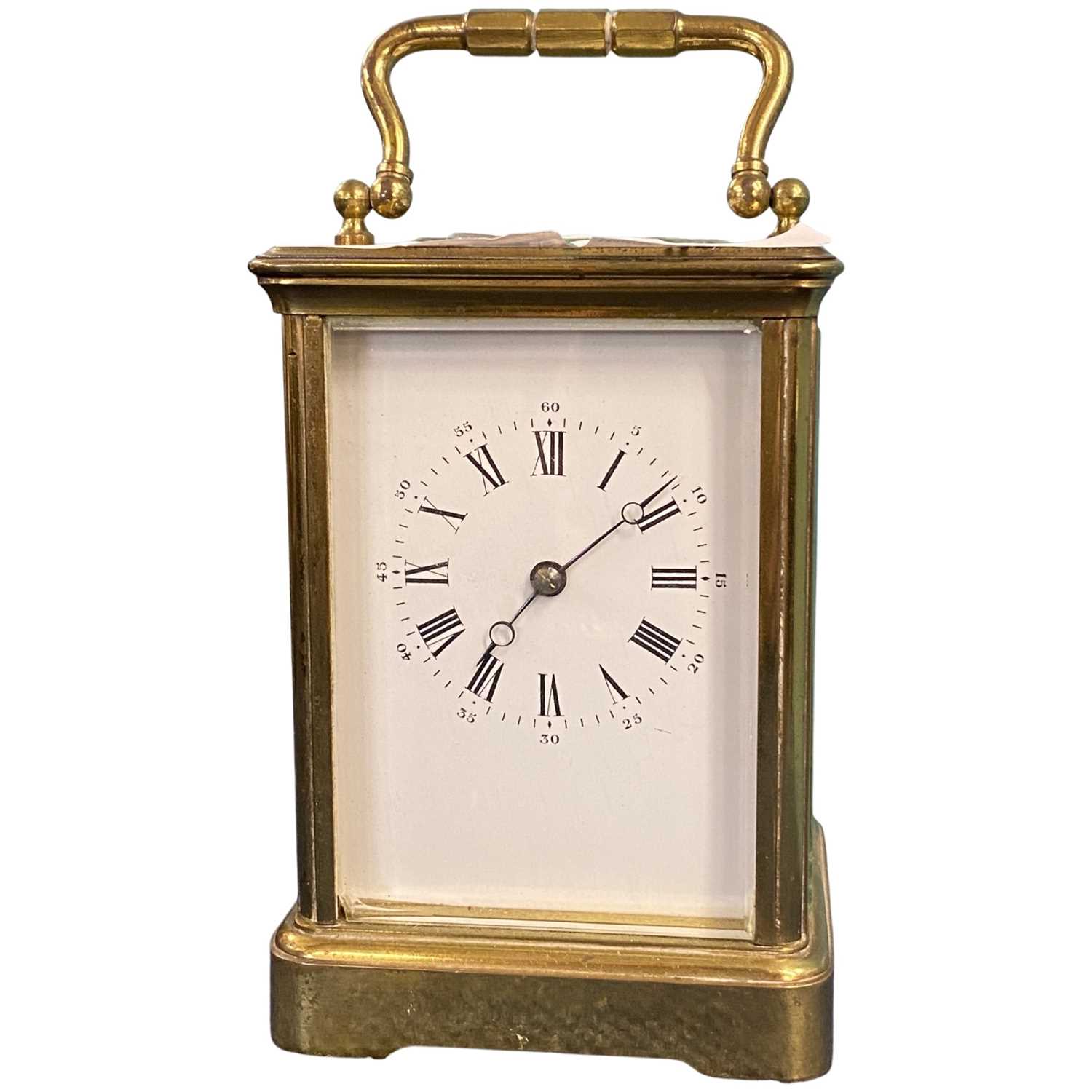 A large early 20th Century brass carriage clock, white enamel dial with Roman numerals,