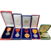 Plastic wallet containing a quantity of overseas awards including Belgium, Germany and others,