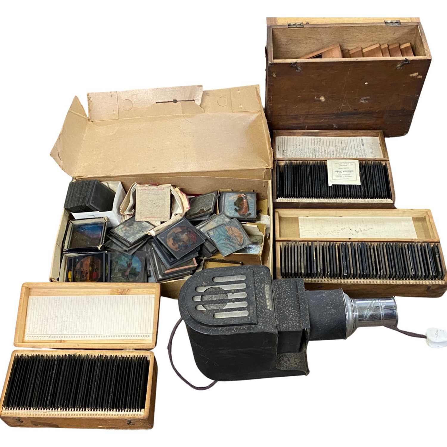 Large plastic box containing Magic Lantern projector and four wooden boxes containing a good