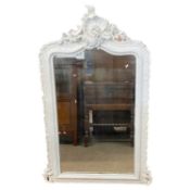 19th Century over mantel mirror of arched form set in a white painted foliate mounted frame, 132cm