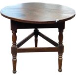 An unusual Georgian mahogany topped cricket type table raised on turned legs, the top 76cm wide