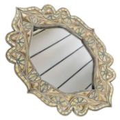 A North African wall mirror set in a foliate form, metal frame, 108cm wide