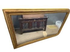 Large 19th Century gilt framed over mantel mirror of arched form, the frame with moulded and