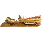 A complete reproduction cast iron fire cart with detachable ladder, original riders and three