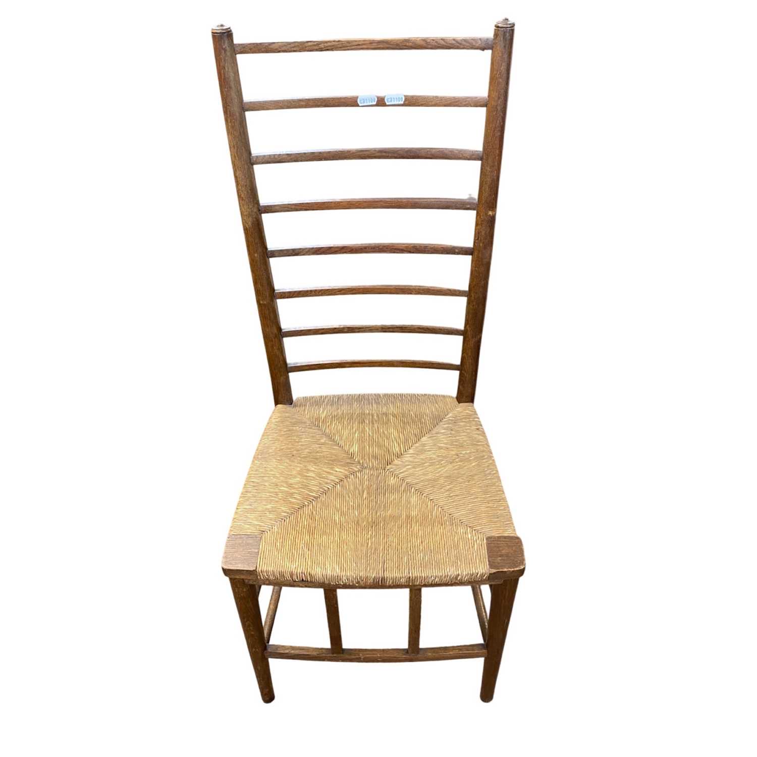 A Arts & Crafts style rush seat ladder back chair, 100cm high