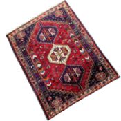 20th Century Middle Eastern wool floor rug decorated with a large central red lozenge, 157cm x