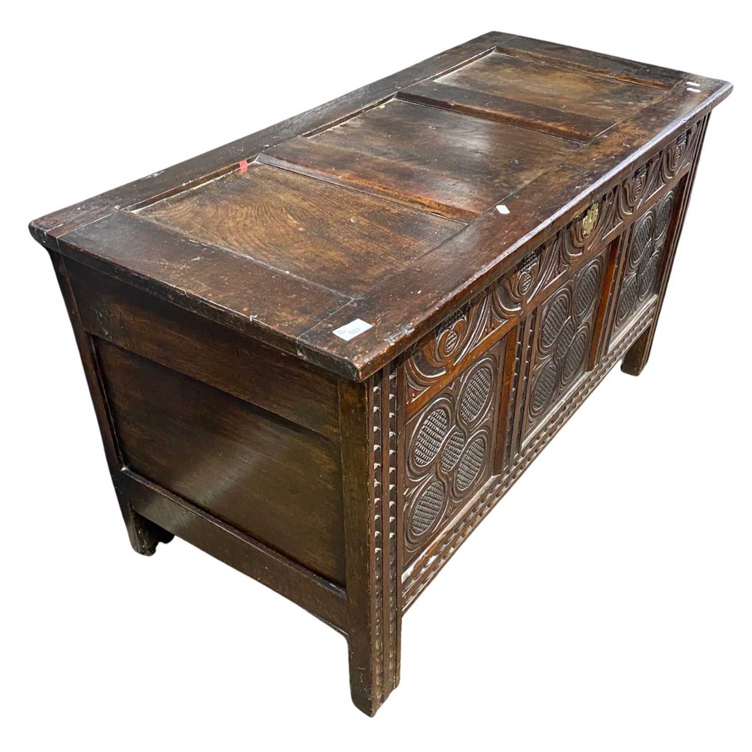 18th Century oak coffer with panelled lid over a carved three panelled front raised on style feet, - Image 4 of 4