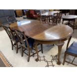 A Georgian Revival mahogany D end dining table with two extension leaves, raised on tapering legs