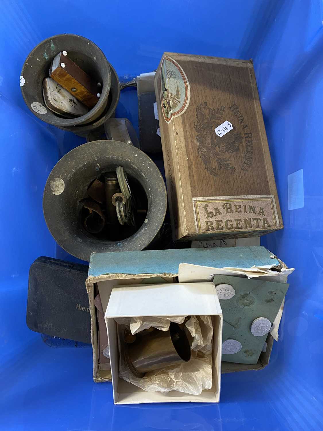 Plastic box containing various items, brass mortar, box with cigars, card with small terracotta