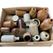 A box containing a collection of mainly ceramic bottles and vintage foot warmers, some Doulton