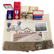 Plastic bag with various items including a vintage belt with Royal Norfolk Regiment badges, Trade