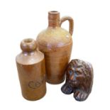 A ginger beer bottle Bourne Denby marked Caley together with a stoneware flask and a treacle