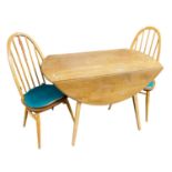 An Ercol drop leaf table and two stick back chairs, table 113cm wide (3)