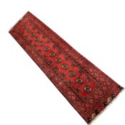 20th Century Pakistani wool runner carpet decorated with lozenges on a principally red background,