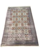 20th Century Middle Eastern shallow pile rug decorated with a central panel of stylised foliage
