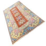 20th Century wool floor rug decorated with large central red panels surrounded by a border of