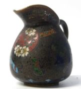 A small Cloisonne jug decorated with a butterfly and flowers