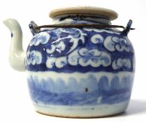 A small Chinese porcelain teapot with wire handle and blue and white decoration