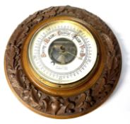 Barometer in wooden frame with raised oak leaf decoration
