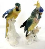 Two figures of parrots on tree stump bases, both Karl Ens Factory, largest 25cm high