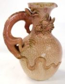 A Royal Worcester style ewer with a pink orange peel ground and dragon handle encircling neck,