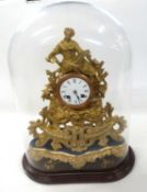 A 19th Century French gilt metal mantel clock with white enamel dial with Roman numerals to a