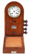 Early 20th Century clock in domed wooden case with calendar below and adjustments for the days and
