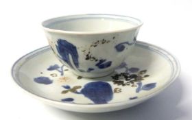 A Chinese porcelain tea bowl and saucer with blue and white decoration from the Nan King Cargo,