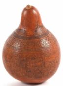An unusual wooden seed container shaped as a pear with panels of incised decoration and title to