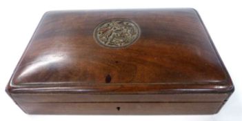 A wooden box with centre roundall of flowers and berries