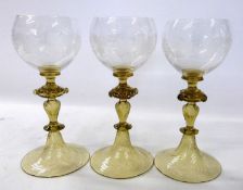 Three Venetian style wine glasses, the bowls with fruiting vine engraved decoration above double