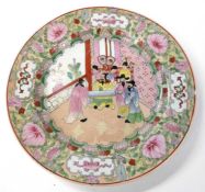 A Chinese porcelain dish with polychrome decoration of Chinese figures within a border of floral