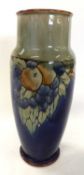 A Royal Doulton vase of cylindrical shape, circa 1930's with a fruit pattern on blue ground, 25cm