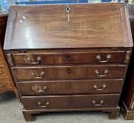 A Georgian mahogany bureau of typical form, the full front opening to an interior with small drawers
