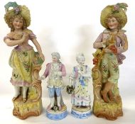 A large pair of continental bisque figurines of gentleman and a lady together with a further