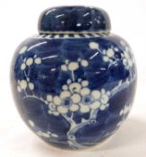 A Chinese porcelain ginger jar and cover, the blue ground with prunus decoration