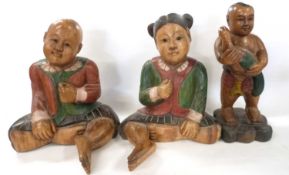 A group of three wooden carved Chinese children, largest 55cm high