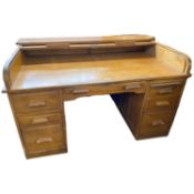 Early 20th Century oak roll top desk with twin pedestals, drop down side leaf, the lock plate