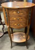 A 20th Century continental side table of oval form decorated with inlaid floral detail and fitted