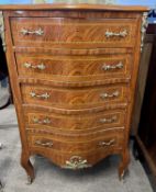 A 20th Century continental serpentine front five drawer chest decorated with a variety of veneers