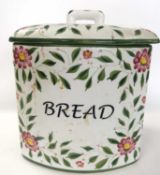 A large ceramic bread bin and cover with painted floral decoration and title to front, painted by