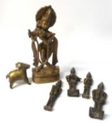 A group of Oriental metal wares including a brass model of a Hindu Deity, four smaller models and