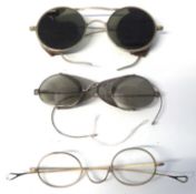 Plastic bag containing two pairs of vintage spectacles in cases and a vintage pair of sunglasses