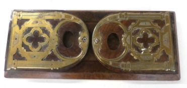 A late 19th Century walnut and brass mounted book slide with gothic decoration, 35cm wide