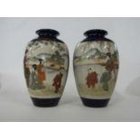 Pair of Japanese Satsuma ware vases, the blue ground with panels of Japanese figures in landscape