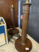 Pair of 20th Century turned hardwood table lamps lacking shades, 56cm high