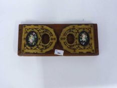 Wooden book ends, each end with a inlaid panel of painted flowers, 35cm long